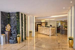 a lobby with a reception desk in a building at Hotel Ramhan Palace in New Delhi