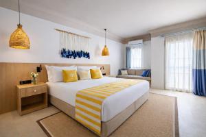 a hotel room with a large bed and a couch at Başka Resort Bodrum in Bodrum City +54 photos