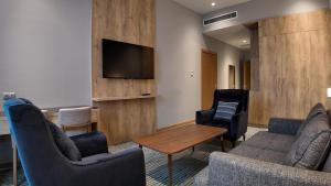 a living room with furniture and a flat screen tv at Naftalan Central Wellness Resort in Naftalan
