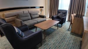 a living room with a couch and chairs and a table at Naftalan Central Wellness Resort in Naftalan +40 photos
