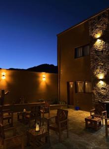 a room with chairs and a building at night at Casa Nuna in Tilcara