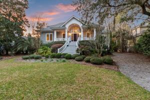 a white house with a porch and a yard at GE317: 317 Glen Eagle in Kiawah Island