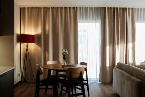 a living room with a table and chairs and a couch at Piano Property Rental Wrocław in Wrocław