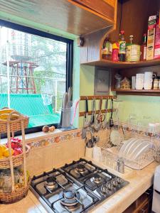 a kitchen with a stove top and a window at Odara Pines Garden The Ridge House 1BR in Baguio