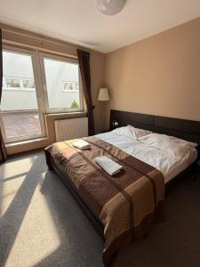 a bedroom with a bed with two towels on it at Hotel Aqua Żyrardów in Żyrardów