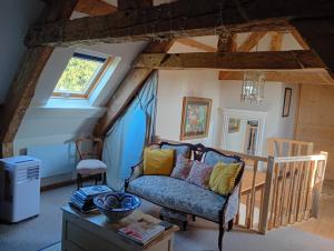 a living room with a couch and a chair at Le Presbytere in Beauficel