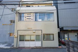 a building with a large window on the side of it at AoiResidence別邸葵 in Nagoya