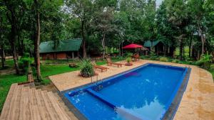 a swimming pool in a yard with a house at Villa viverra in Polonnaruwa