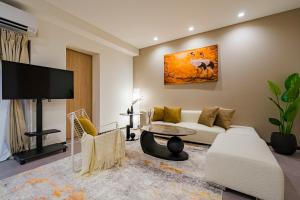 a living room with a couch and a tv at AoiResidence別邸葵 in Nagoya