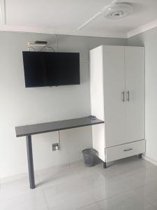 a desk and a white cabinet in a room at Florino GuestHouse in Rundu +67 photos