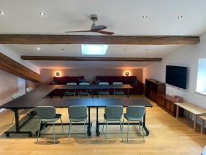 a room with a table and chairs and a couch at Très bel hôtel particulier avec loft et salle de séminaire in Étoile-sur-Rhône +56 photos
