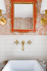 a bathroom with a sink and a mirror on the wall at The Forest Door - Studio Suite in Stone Cottage in Tryon