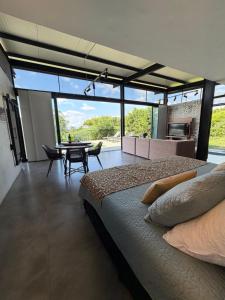 a bedroom with a bed and a dining room with a table at Belvedere Suite Campestre in Alcalá +59 photos