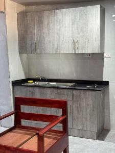 a kitchen with a sink and a counter top at Longacres Cottage in Lusaka