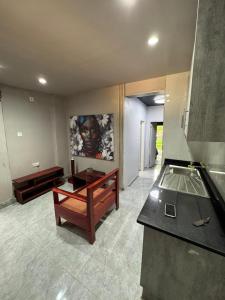 a living room with a table and a counter at Longacres Cottage in Lusaka