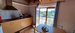 a kitchen with a table and a large window at Apartamentos Turísticos San Cristóbal by Bossh! Hotels in Cuenca