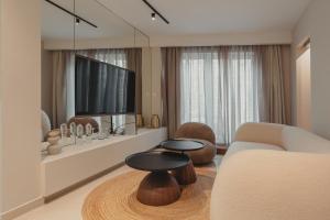 a living room with a couch and a table at Anemos Luxury Grand Resort in Georgioupolis