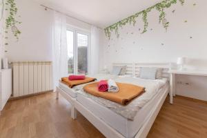 a bedroom with a bed with two pillows on it at Bella Vista apartments in Koper