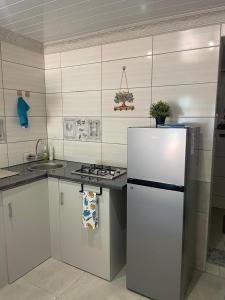 a kitchen with a white refrigerator and a sink at Shady Seringa Accommodation in Vanderbijlpark