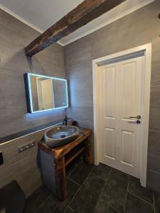 a bathroom with a sink and a mirror at Appartement Neckartal in Hirschhorn +12 photos