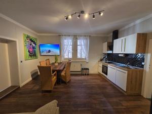 a kitchen and dining room with a table and chairs at Appartement Neckartal in Hirschhorn