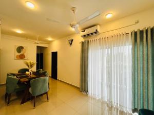 a dining room with a table and a large window at Santorini VIP Apartment Negombo in Negombo
