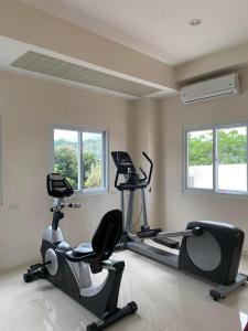 a gym with two exercise bikes in a room at Thyme Residence The VAs Nest Near Anjo World Free Pool and Gym in Minglanilla +7 photos