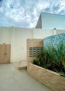 a building with a garden in front of it at Thyme Residence The VAs Nest Near Anjo World Free Pool and Gym in Minglanilla