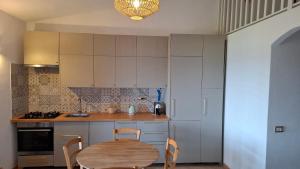 a kitchen with a wooden table and a table and chairs at Villetta Vista Paradiso in Costa Paradiso +14 photos