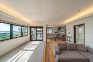 a living room with a couch and a table at LAGUNA OKINAWA Beachfront YAKA in Kin