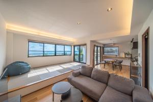 a living room with a couch and a table at LAGUNA OKINAWA Beachfront YAKA in Kin