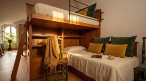 a bedroom with a bunk bed with a ladder at Edoardo Historic House in Gubbio
