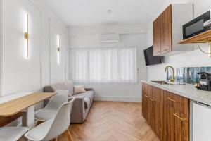 a kitchen and living room with a couch and a table at Sublime brand-new studio with air conditioning in Plaisance-du-Touch