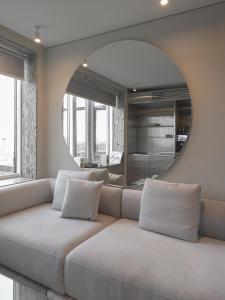 a living room with a couch and a mirror at Lesi City Guide Hotel in Kyiv +77 photos