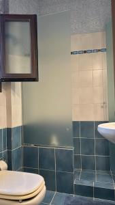 a bathroom with a toilet and a sink at The Jasmine Hill in Aegenitissa