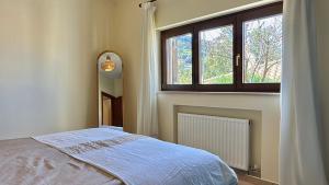 a bedroom with a bed and a window at The Jasmine Hill in Aegenitissa