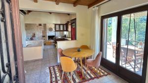 a kitchen and dining room with a table and chairs at The Jasmine Hill in Aegenitissa