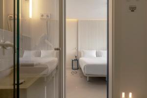 a hotel room with two beds and a mirror at SLEEP'N Valencia in Valencia +73 photos