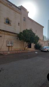 a white car parked in front of a building at Izdihar Dalis Suites in Quai