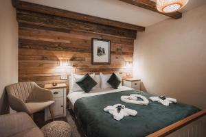 a bedroom with a bed with towels on it at Chalet Evergreen in Borovets