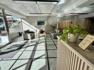 a lobby with couches and chairs in a building at NBH Premier Hotel in San Carlos de Bariloche