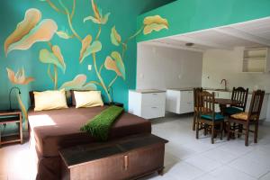 a bedroom with a bed with a painting on the wall at casaJOMO in Rio de Janeiro