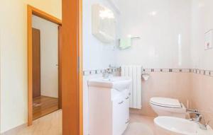 a bathroom with a toilet and a sink and a mirror at Apartments Villa Teuta in Umag +14 photos
