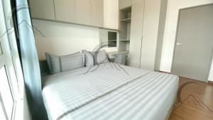 a bedroom with a bed with white and blue pillows at The Moonlight Valley Sri Indah in Sandakan +17 photos