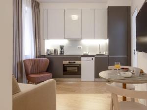 a kitchen and living room with a table and chairs at LSA Santos by Numa in Lisbon