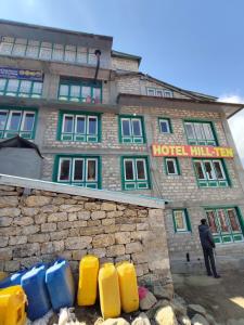 a man standing in front of a hotel at Hill-Ten in Namche