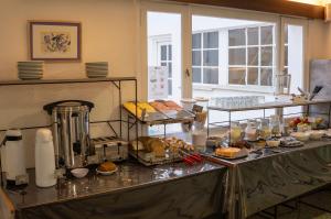 a kitchen with a buffet of food on a counter at NBH Premier Hotel in San Carlos de Bariloche