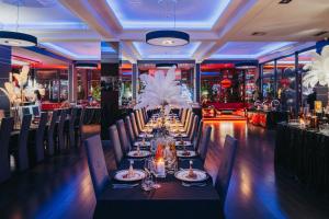 a long dining room with a long table with white flowers at Hotel Soray in Wieliczka