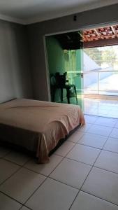 a bedroom with a bed and a view of a patio at exclusivamente para agrishow e João rok in Ribeirão Preto