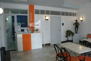 a room with a table and chairs and a kitchen at Hostal Puerto Beach in Motril
